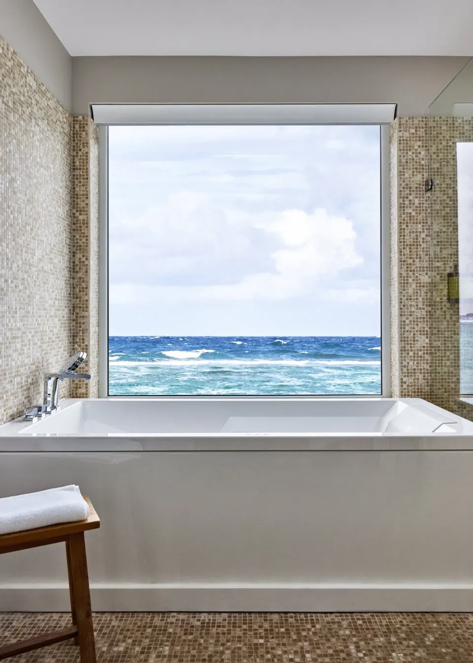 Admiral Suite bathtub with large ocean-view window at Rosewood Le Guanahani St Barth.