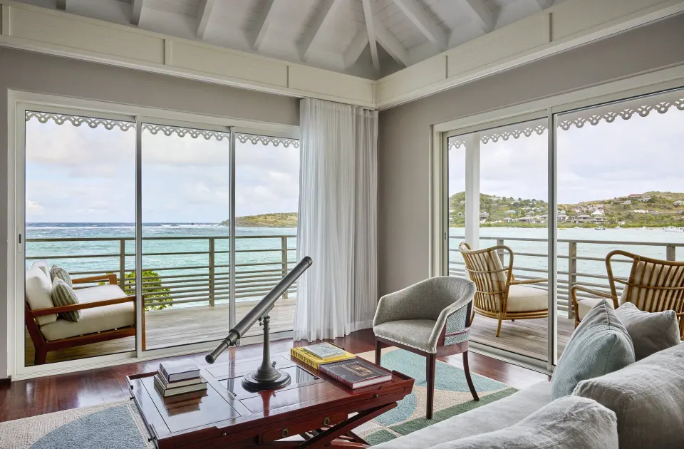 Admiral Suite sitting area with balconies and water views at Rosewood Le Guanahani St Barth.