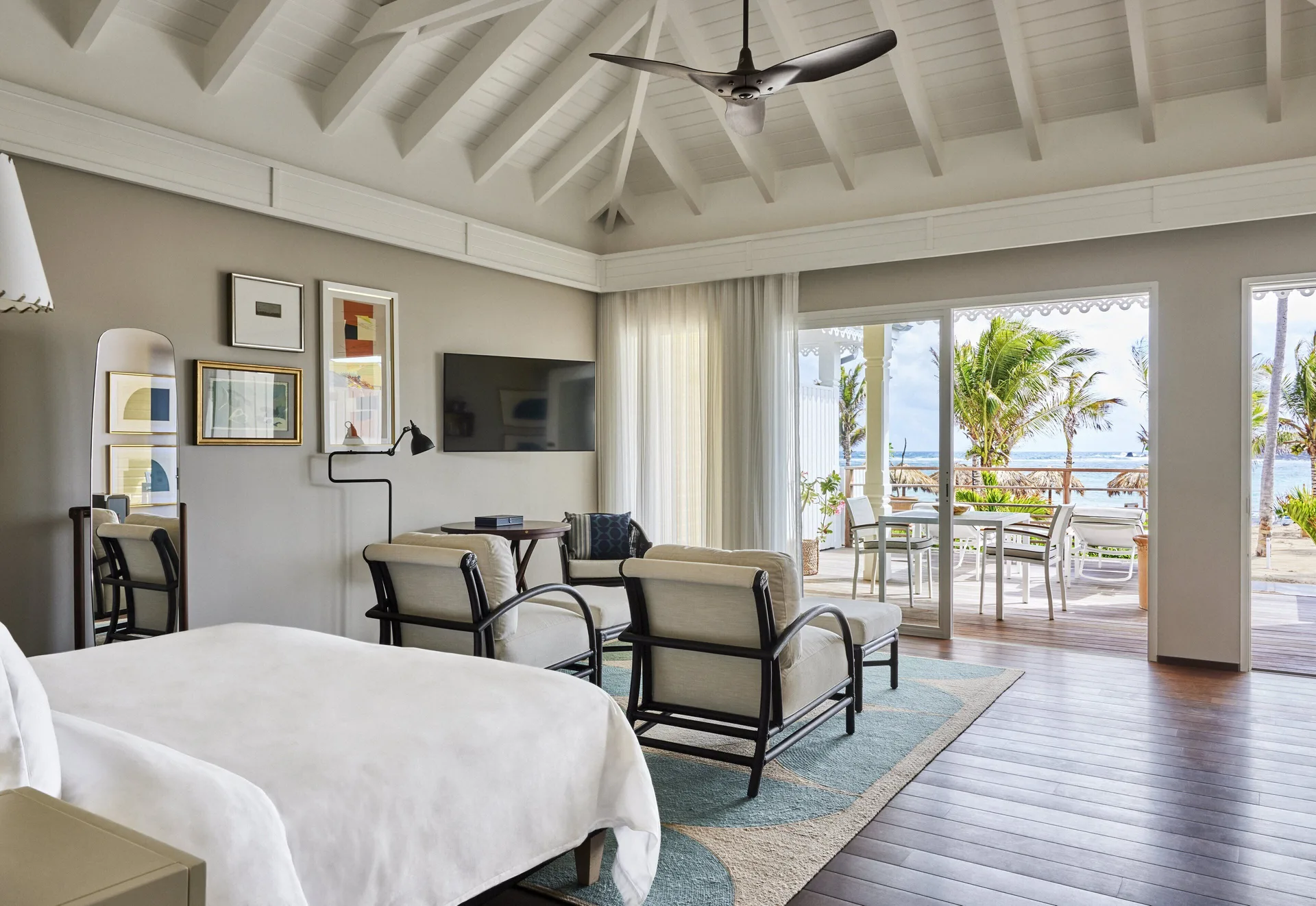 Beach Room with king bed, seating, and terrace view at Rosewood Le Guanahani St Barth.