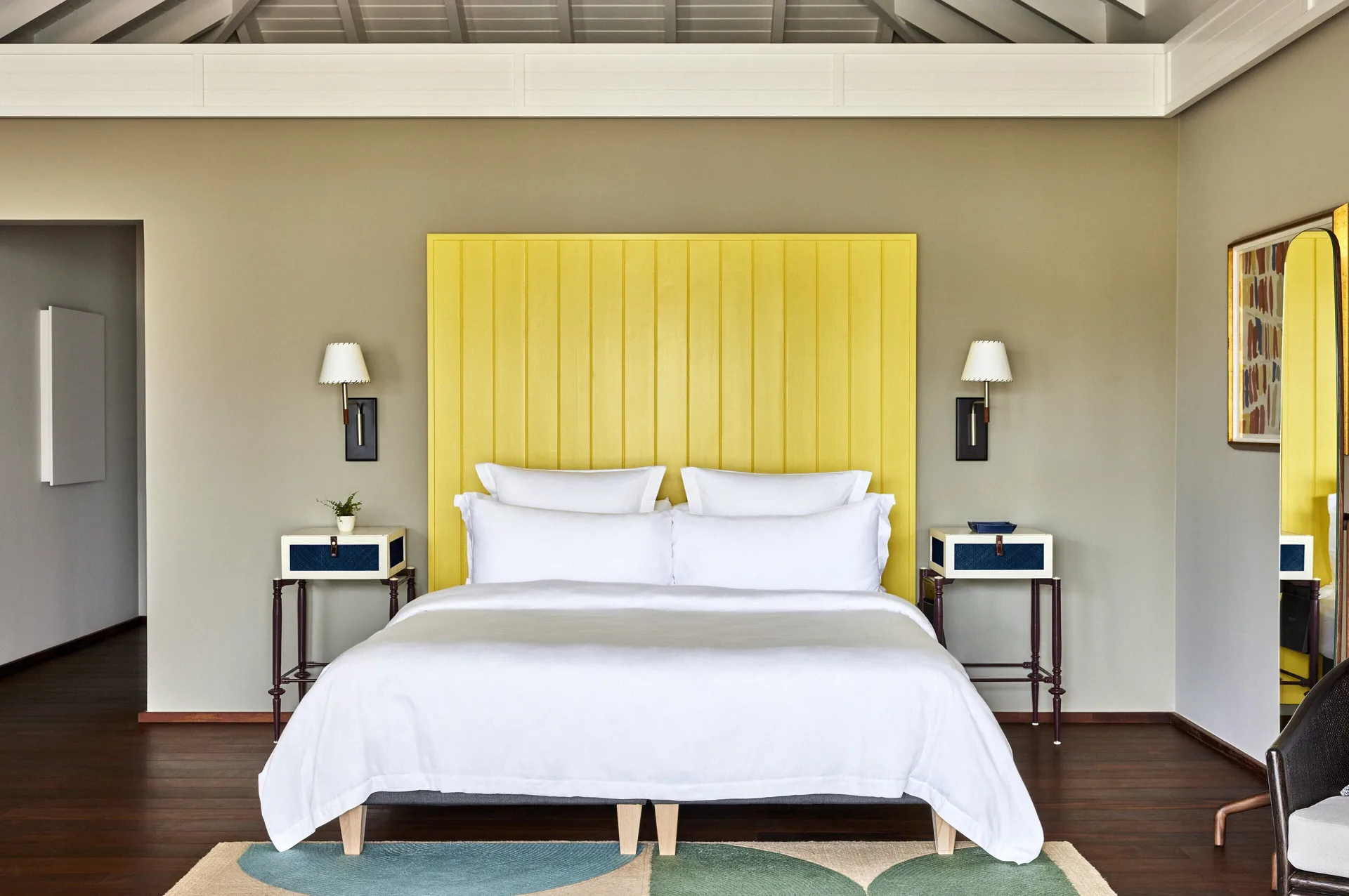 Beach Room king bed with yellow headboard at Rosewood Le Guanahani St Barth.