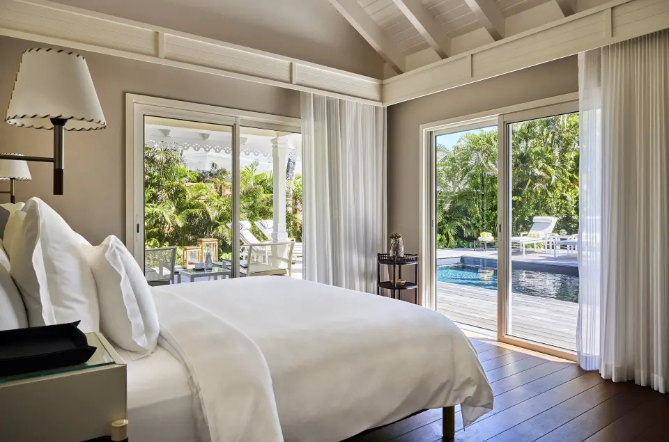 Garden House bedroom with king bed and pool view at Rosewood Le Guanahani St Barth.