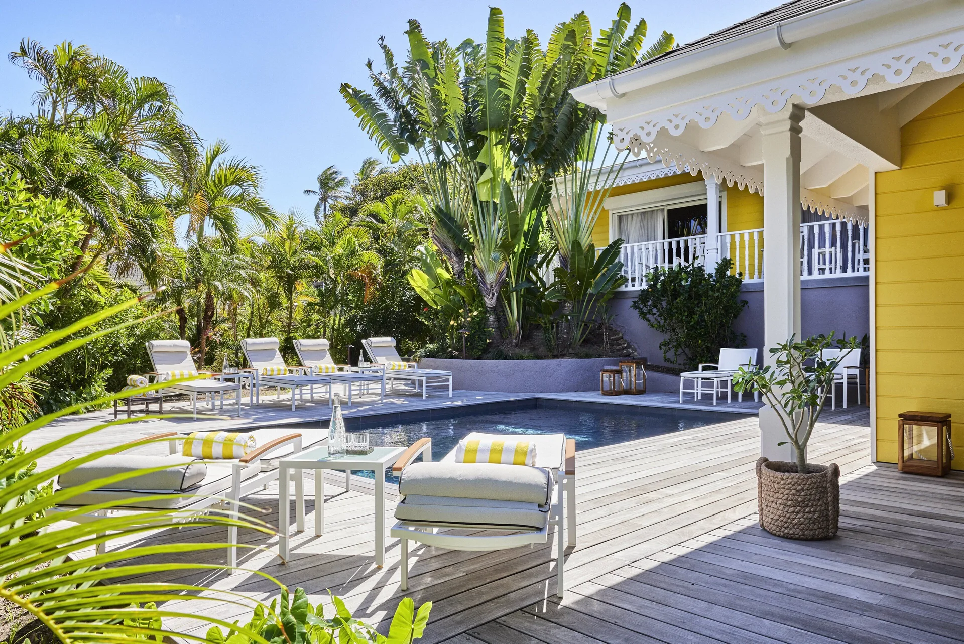 Garden House pool deck with loungers and yellow exterior at Rosewood Le Guanahani St Barth.