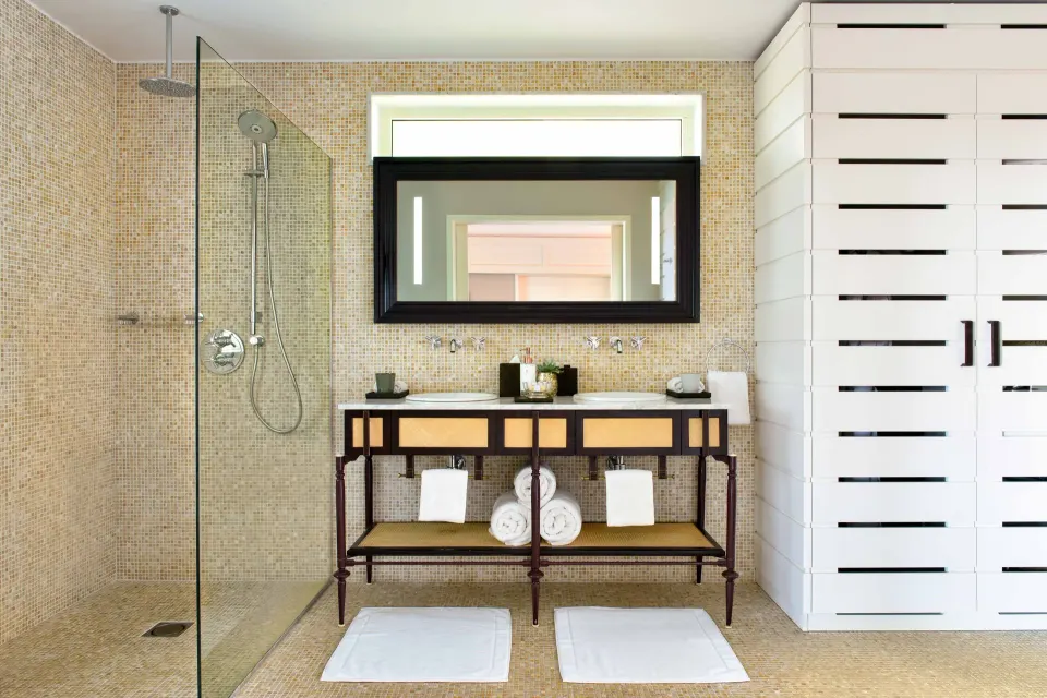 Garden Suite bathroom with double vanity and glass shower at Rosewood Le Guanahani St Barth.