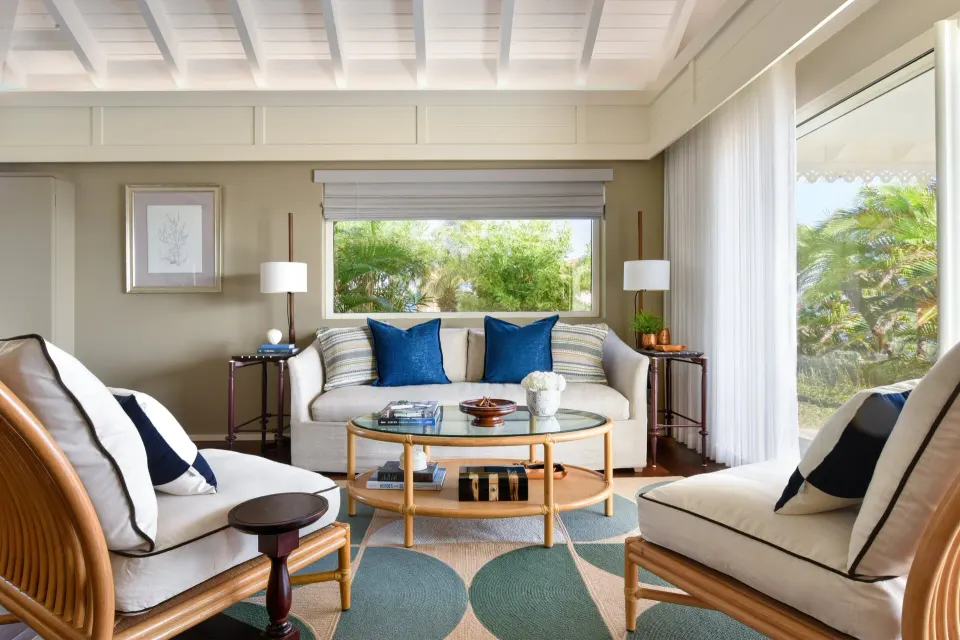 Garden Suite sitting room with garden views and rattan chairs at Rosewood Le Guanahani St Barth.