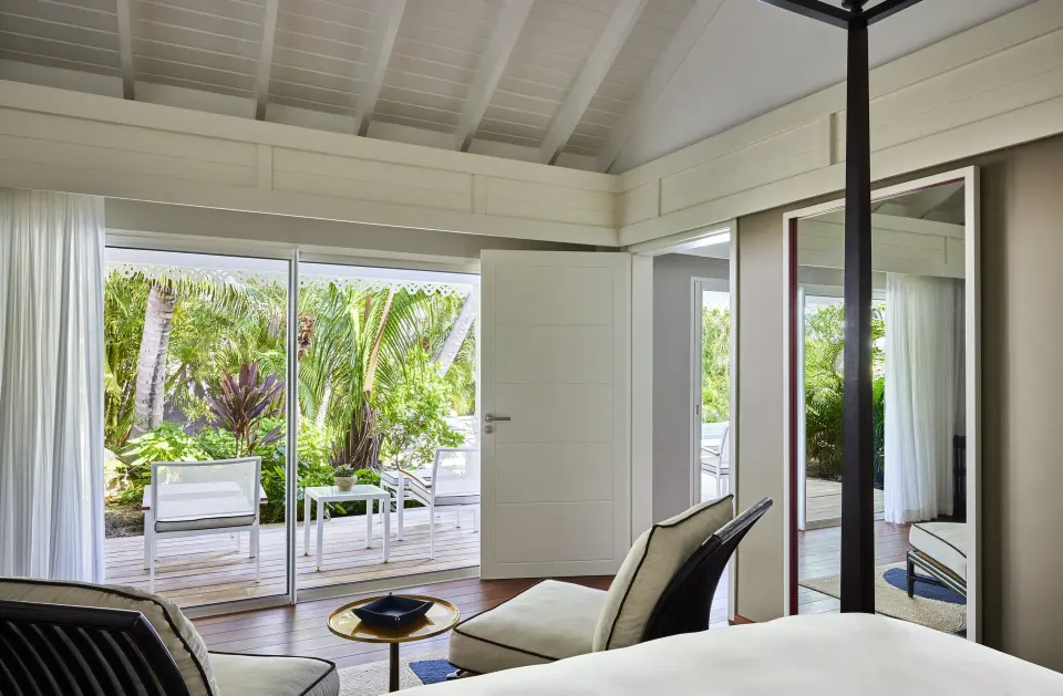 Hibiscus Suite bedroom seating and garden terrace at Rosewood Le Guanahani St Barth.