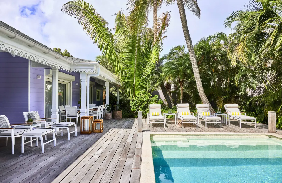 Hibiscus Suite deck with pool, loungers and palms at Rosewood Le Guanahani St Barth.