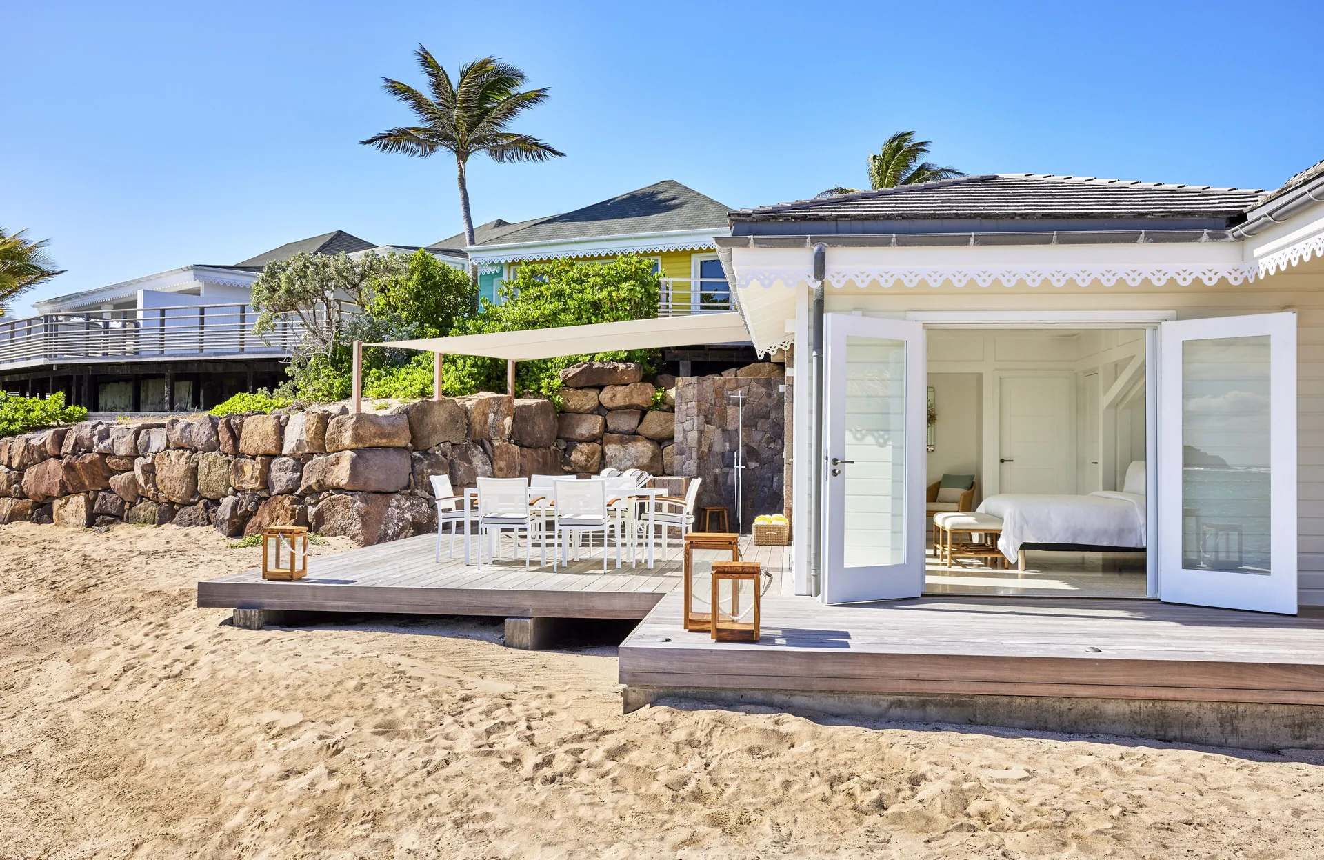 Lagoon Suite beachfront terrace and open bedroom doors at Rosewood Le Guanahani St Barth.