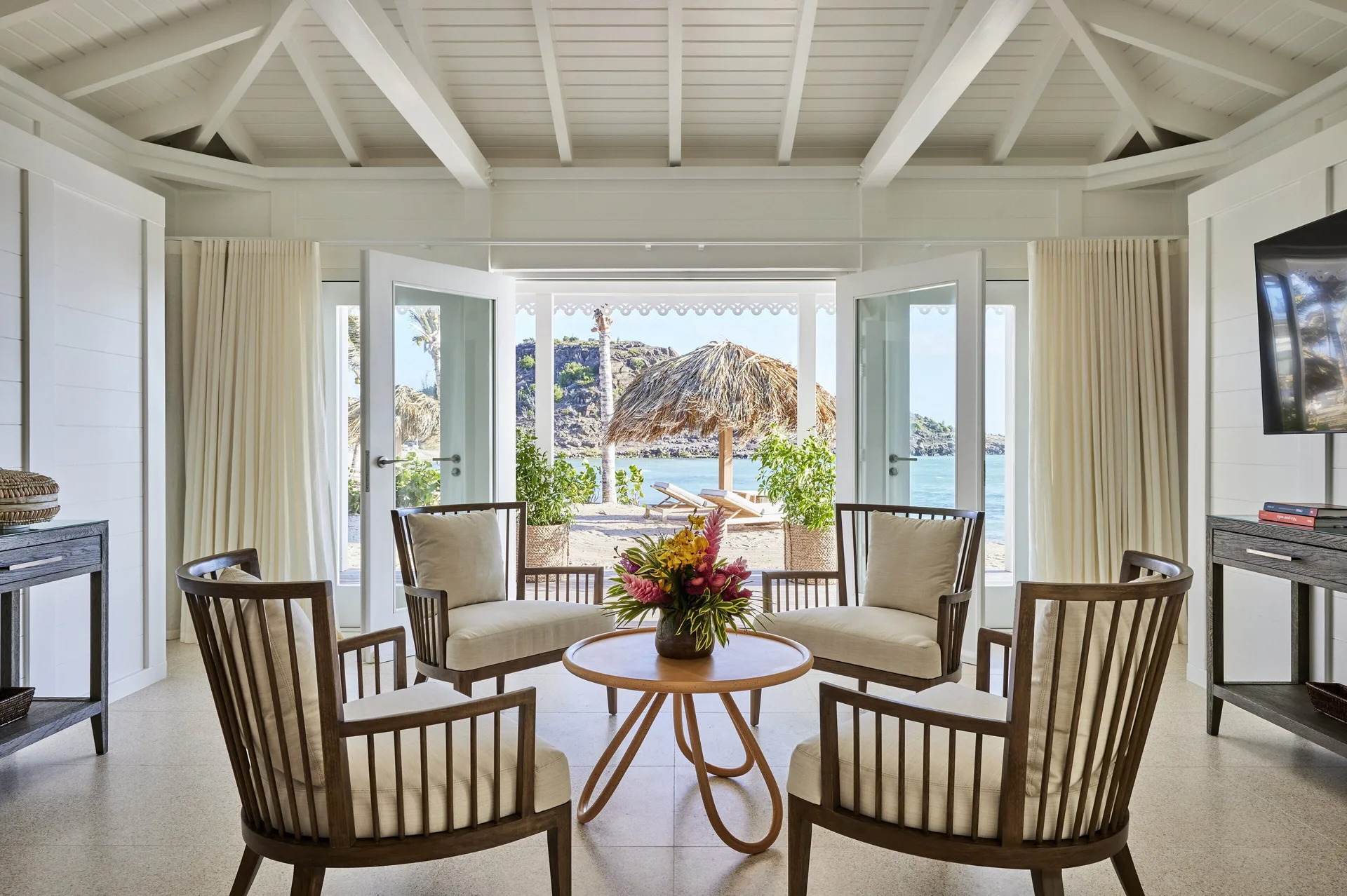 Lagoon Suite sitting room opens to a beach terrace at Rosewood Le Guanahani St Barth.