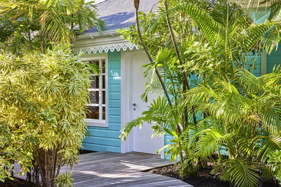 Marigot Suite turquoise exterior and garden entry at Rosewood Le Guanahani St Barth.