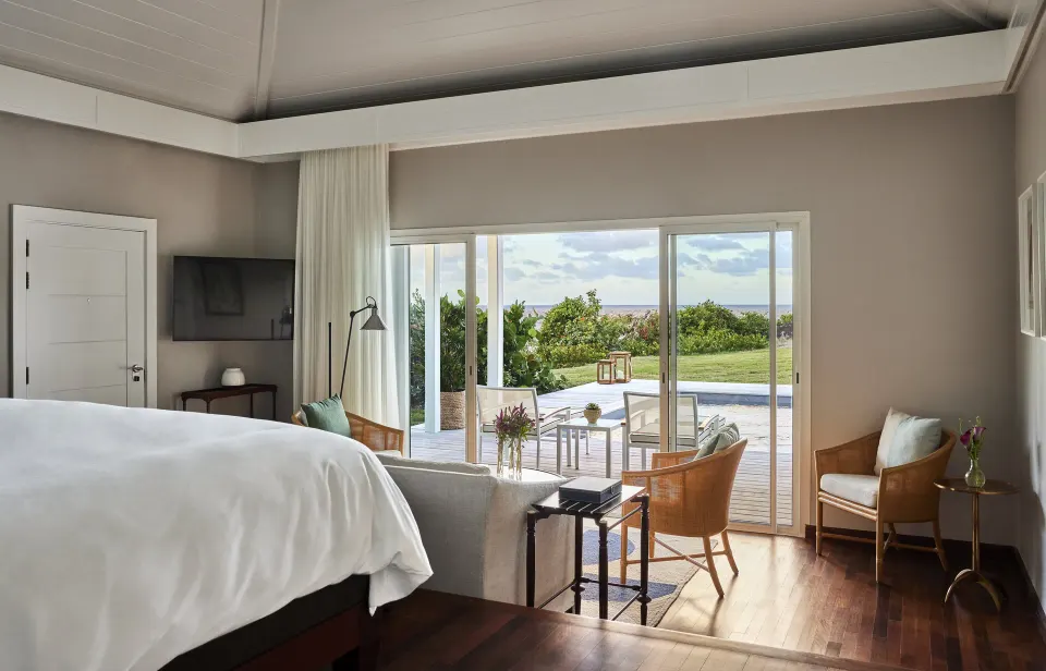 Marigot Suite bedroom with king bed and terrace doors at Rosewood Le Guanahani St Barth.