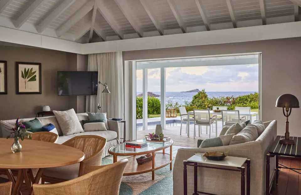 Marigot Suite living room opens to an ocean-facing terrace at Rosewood Le Guanahani St Barth.