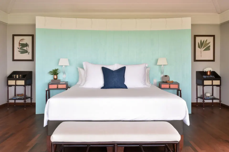 Ocean Bay Room king bed with aqua headboard at Rosewood Le Guanahani St Barth.