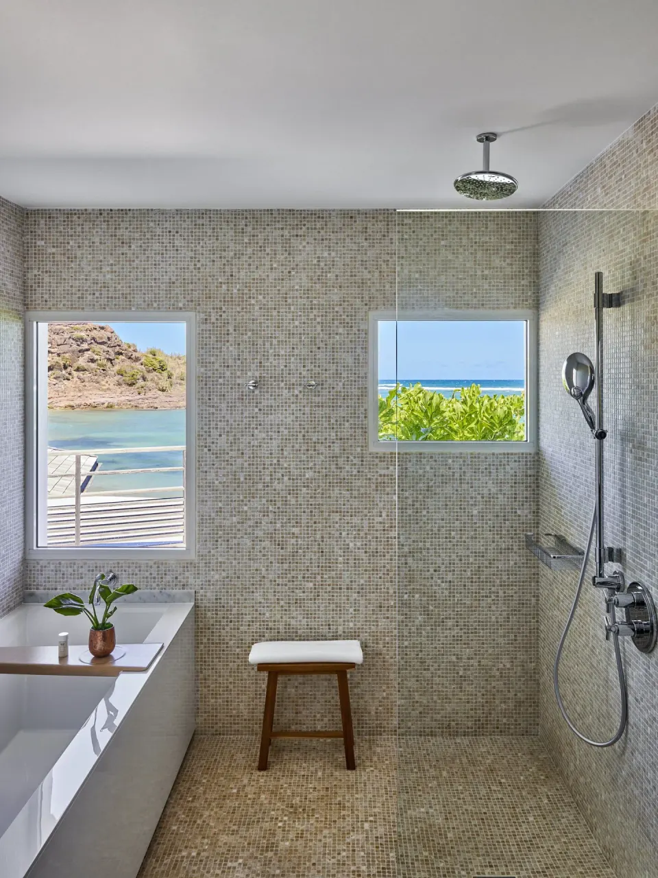 Ocean Cove Junior Suite bathroom with shower and ocean windows at Rosewood Le Guanahani St Barth.