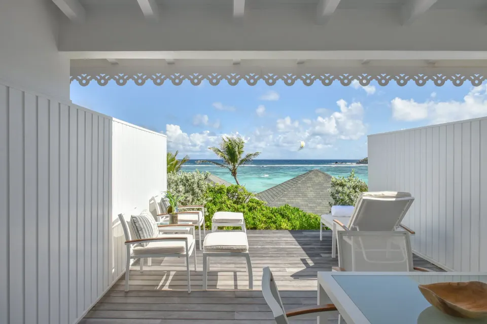 Ocean Cove Room terrace with loungers and ocean view at Rosewood Le Guanahani St Barth.