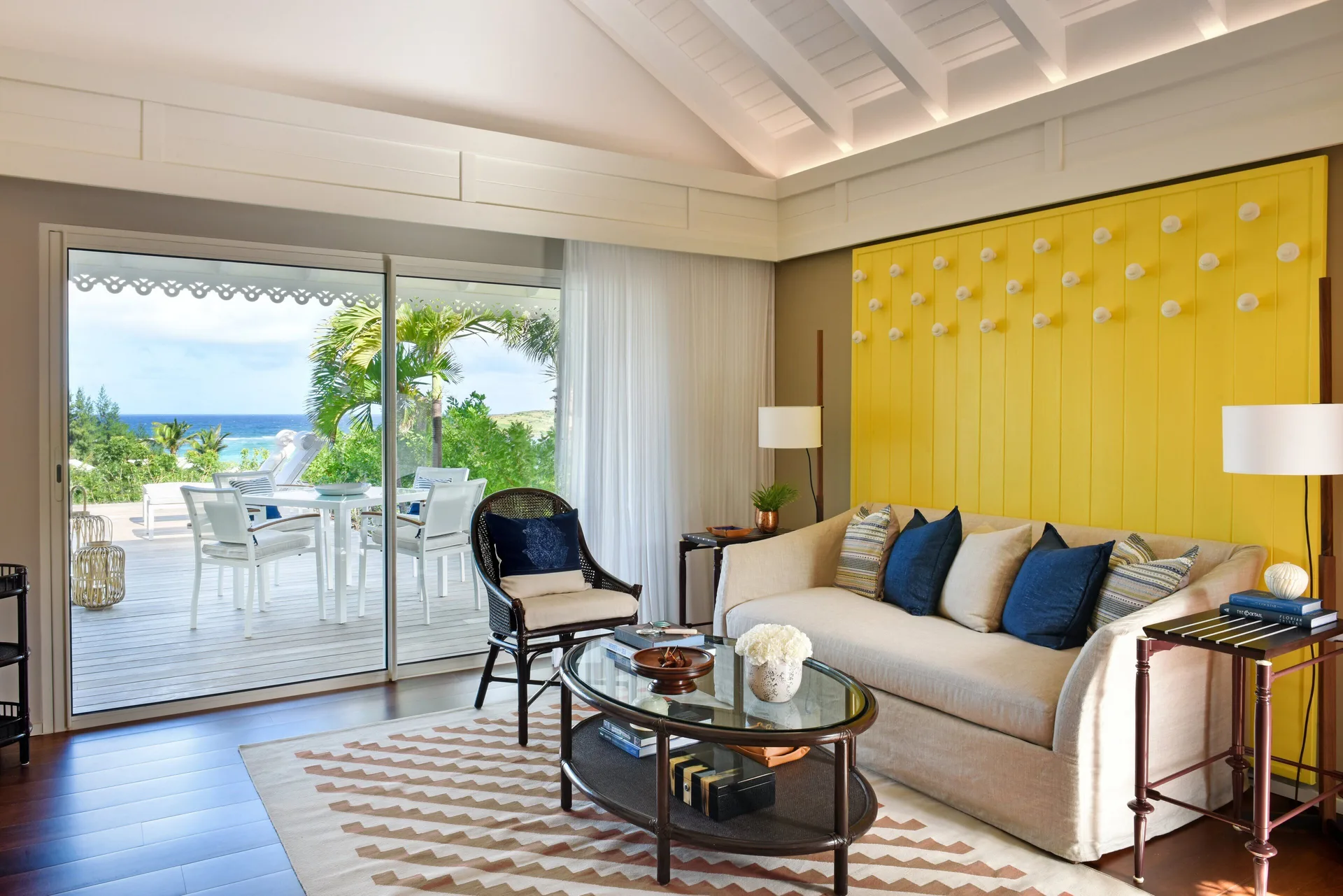 Ocean View Suite living room opening to an ocean-view deck at Rosewood Le Guanahani St Barth.