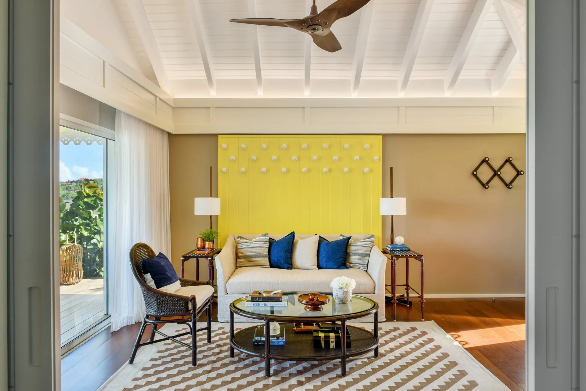 Ocean View Suite living room with sofa and terrace doors at Rosewood Le Guanahani St Barth.