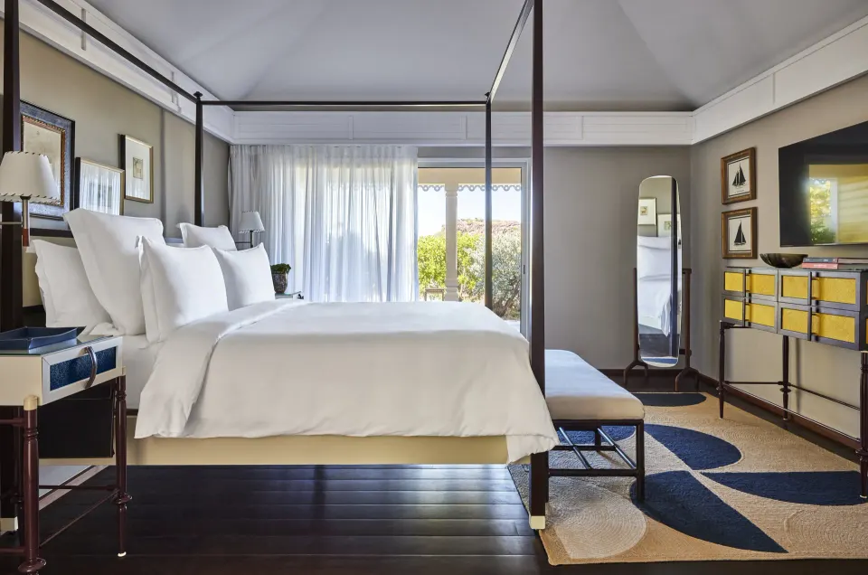 Pelican Suite four-poster king bed and sitting area at Rosewood Le Guanahani St Barth.