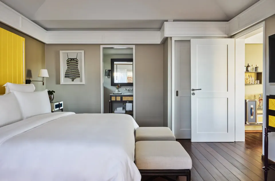 Pelican Suite king bedroom and bathroom doorway at Rosewood Le Guanahani St Barth.