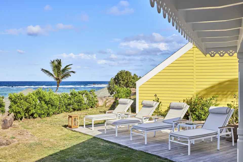 Pelican Suite ocean-facing terrace with lounge chairs at Rosewood Le Guanahani St Barth.