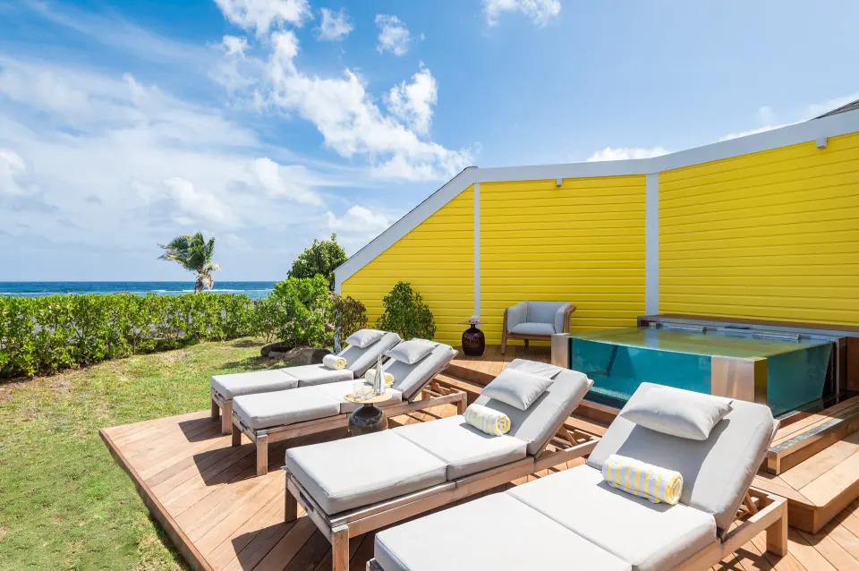 Pelican Suite deck with plunge pool and loungers at Rosewood Le Guanahani St Barth.