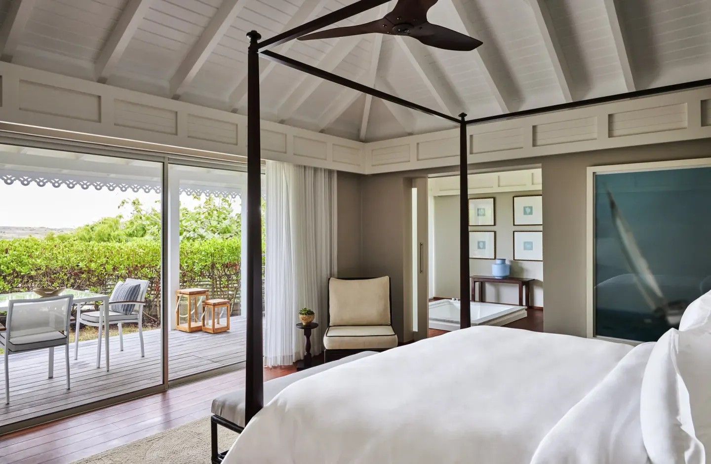 Serenity Suite four-poster bed and terrace doors at Rosewood Le Guanahani St Barth.