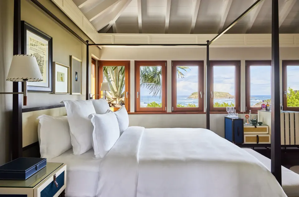 Wellness Junior Suite bedroom with four-poster bed at Rosewood Le Guanahani St Barth.