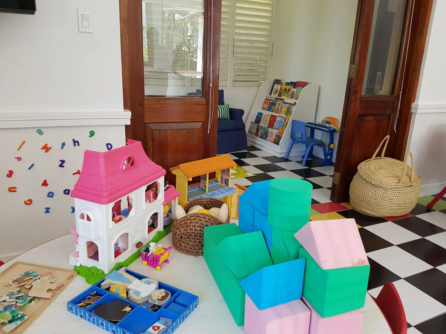 Children's playroom with toys, books and foam blocks at Round Hill Hotel And Villas.