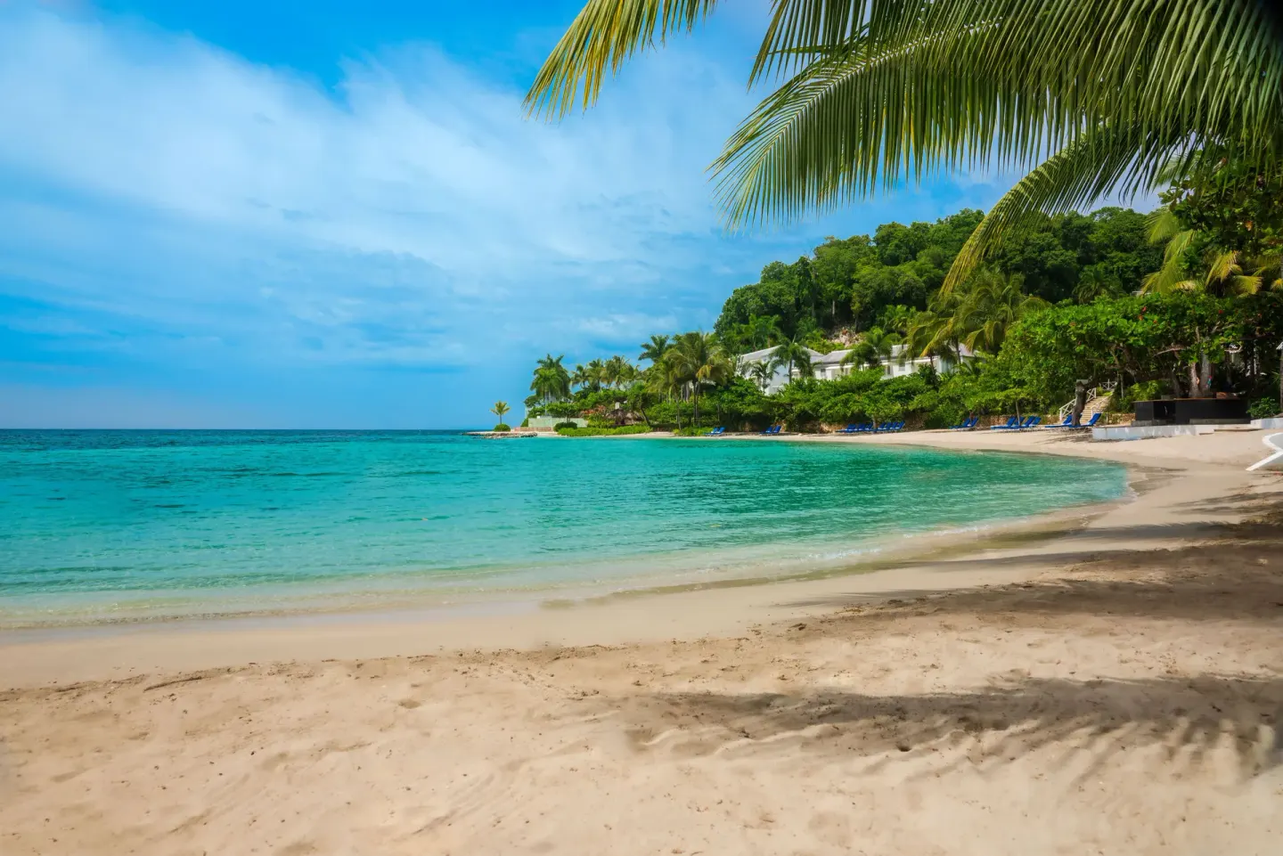 Curved sandy beach and turquoise bay at Round Hill Hotel And Villas.