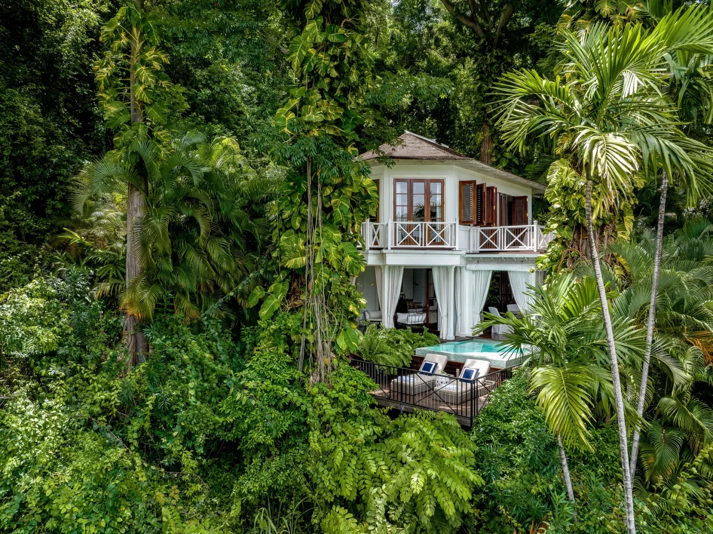 Two-story villa with a private pool in tropical foliage at Round Hill Hotel And Villas.