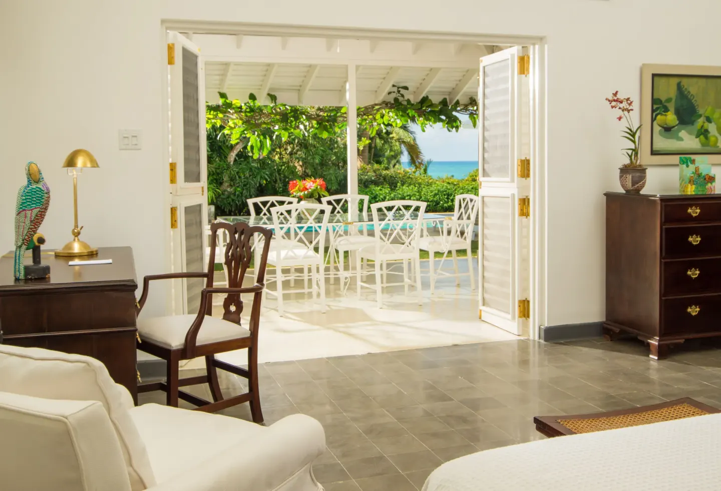 Villa bedroom opening to a furnished terrace at Round Hill Hotel And Villas.