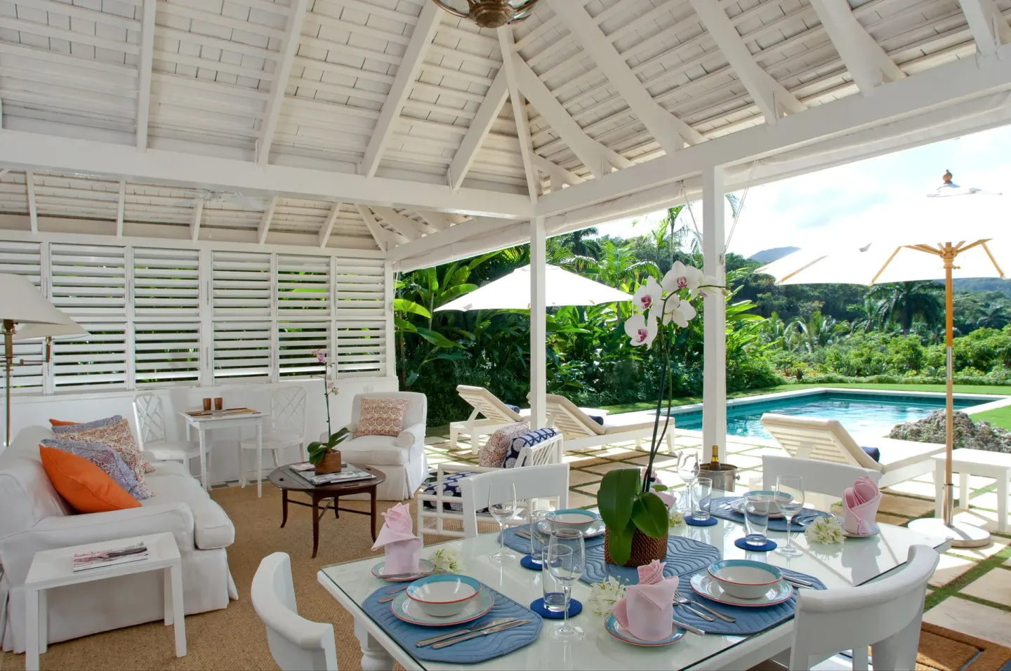 Open-air villa dining and lounge by the pool at Round Hill Hotel And Villas.