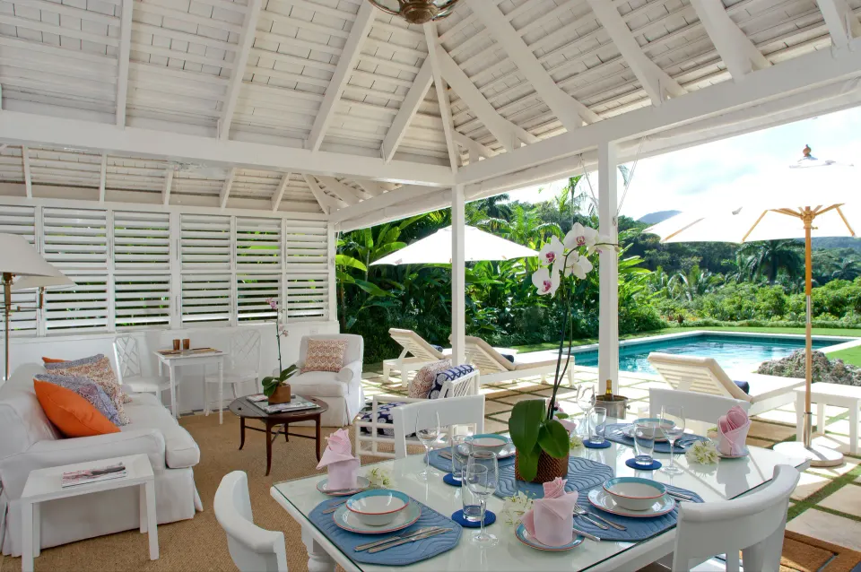 Open-air villa dining and lounge by the pool at Round Hill Hotel And Villas.