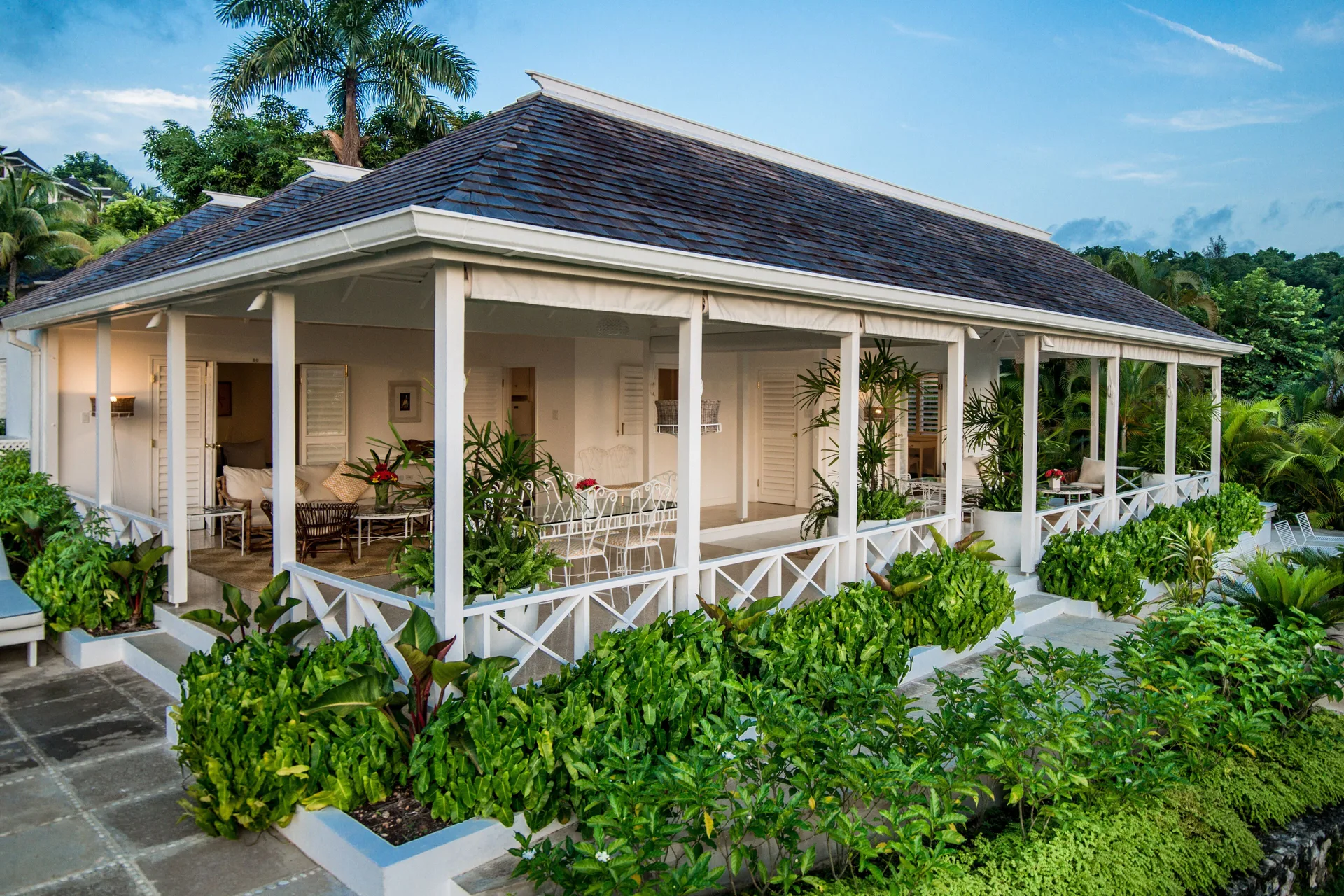 Classic Villa exterior with wraparound veranda at Round Hill Hotel And Villas.