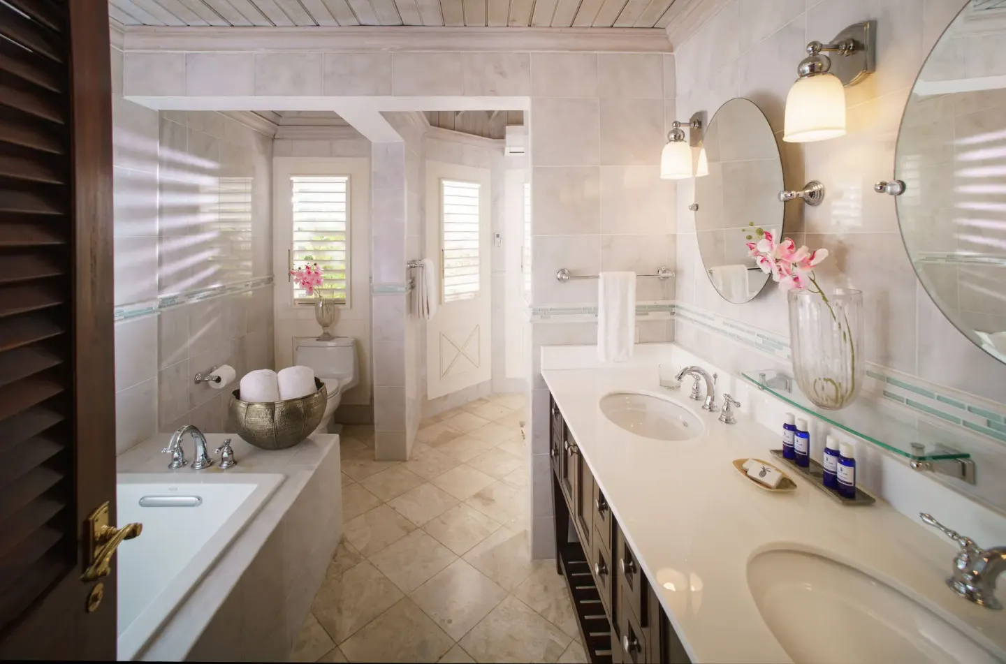 Double vanity and bathtub in a classic villa bathroom at Round Hill Hotel And Villas.