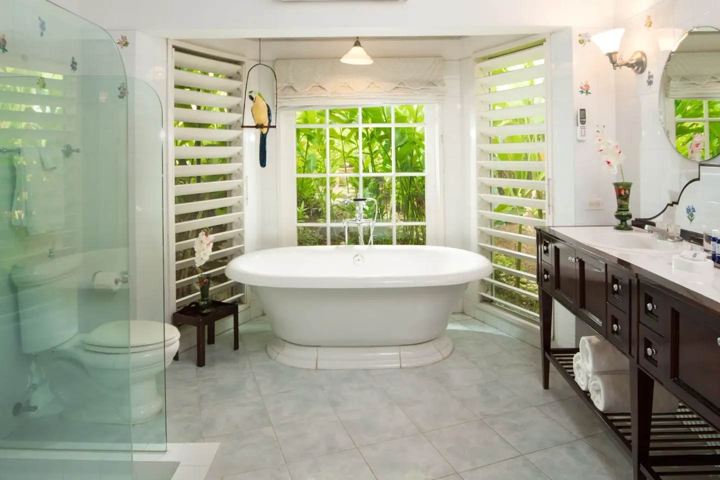 Freestanding tub and glass shower in a classic villa bathroom at Round Hill Hotel And Villas.