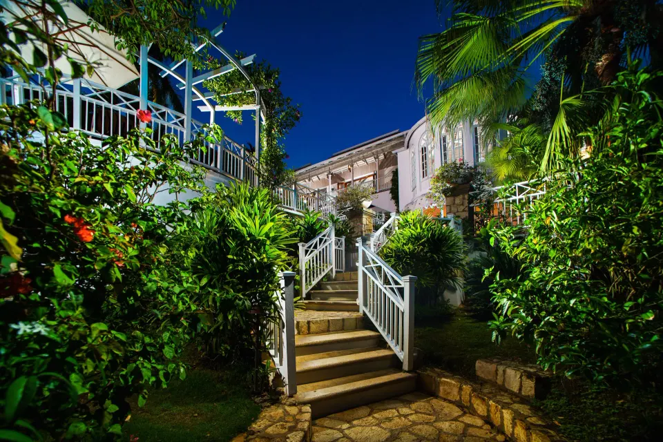 Garden stairs lead to a classic villa exterior at Round Hill Hotel And Villas.
