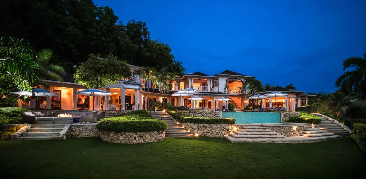 Estate Villa 5 Bedroom exterior and pool at dusk at Round Hill Hotel And Villas.