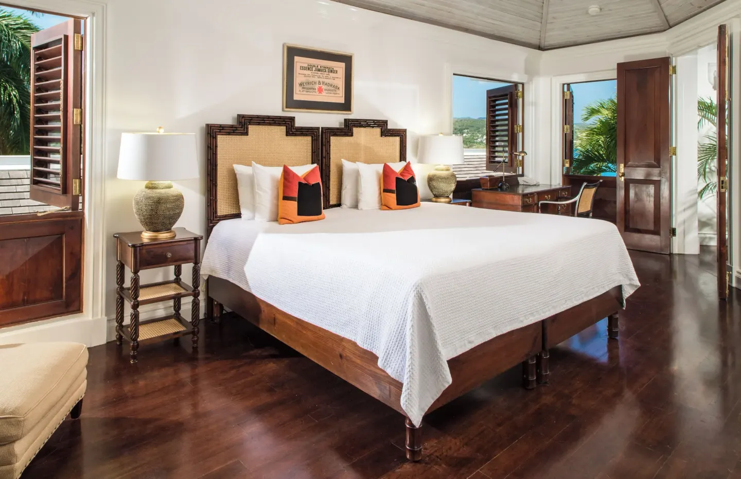 Estate Villa 5 Bedroom guest room with a large bed and open shutters at Round Hill Hotel And Villas.