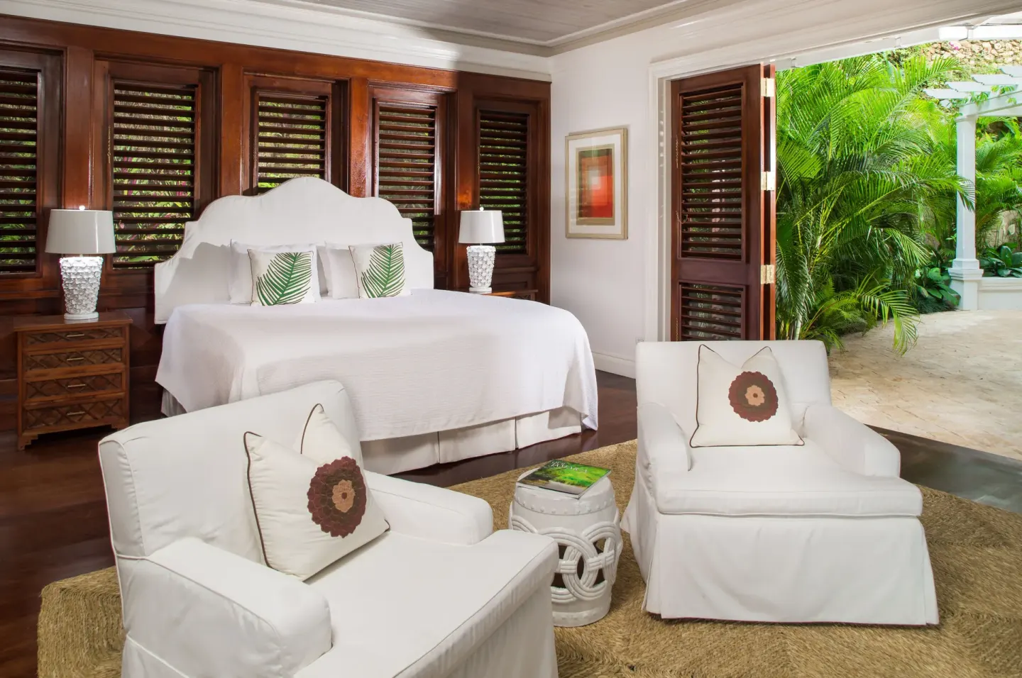White bed and lounge chairs in Estate Villa 5 Bedroom at Round Hill Hotel And Villas.