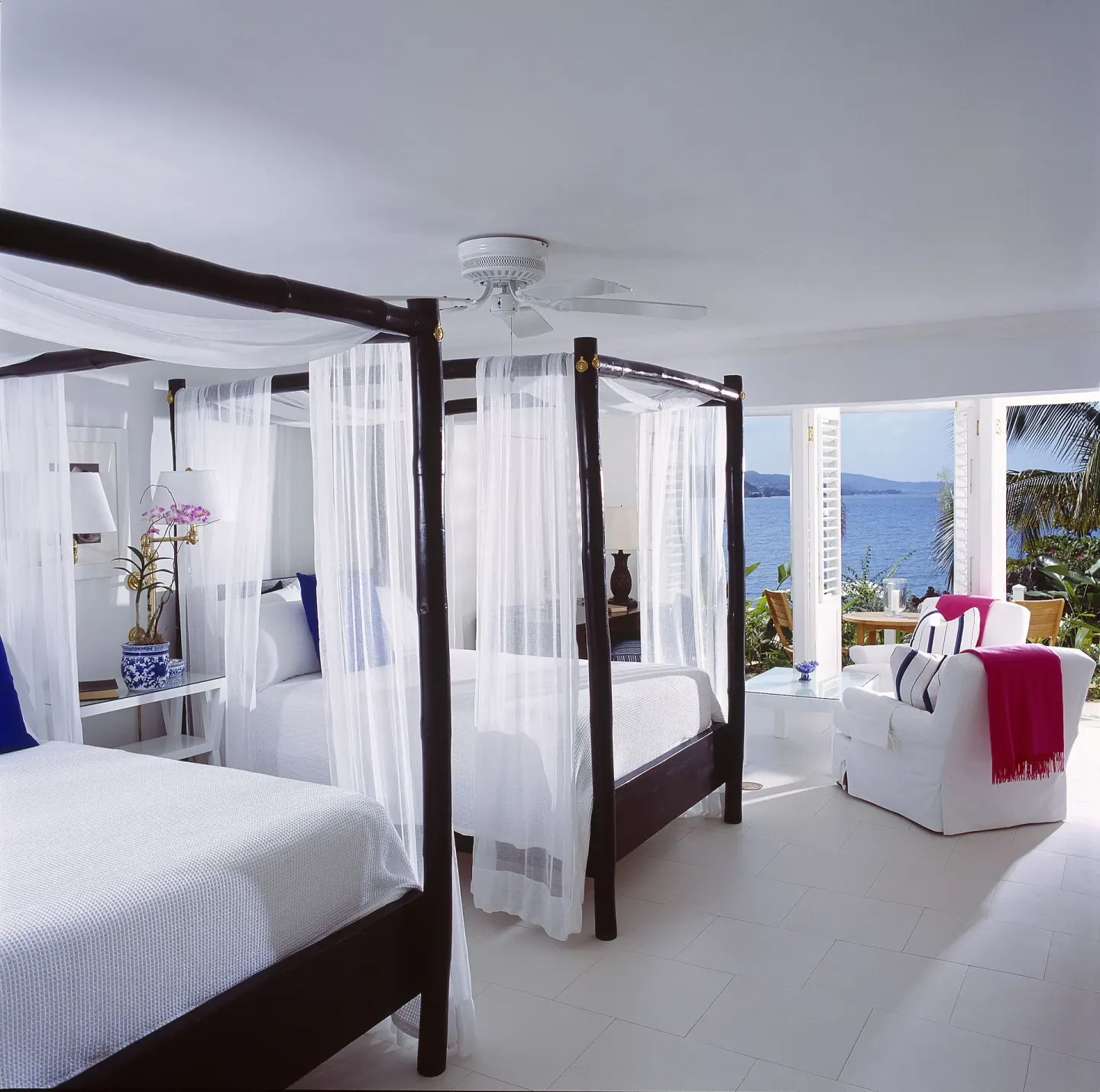 Oceanfront Premium Room with two canopy beds and sea view at Round Hill Hotel And Villas.