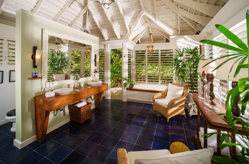 Spacious villa bathroom with double vanity and tub at Round Hill Hotel And Villas.