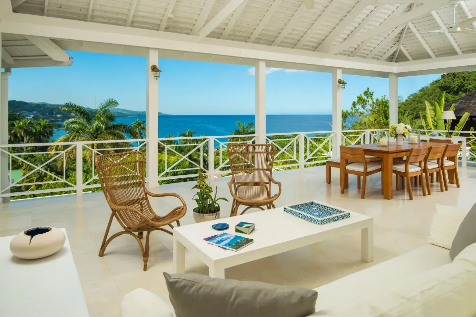 Covered terrace with ocean view at a Signature Villa at Round Hill Hotel And Villas.