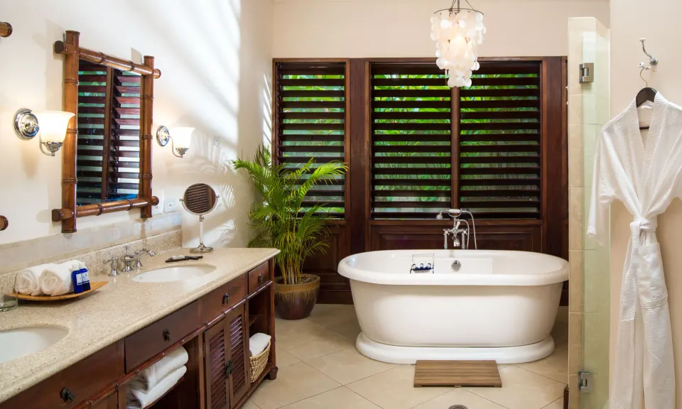 Bathroom with freestanding tub and double vanity at Round Hill Hotel And Villas.