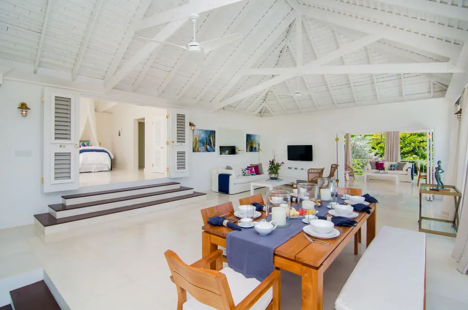 Open living and dining area inside a Signature Villa at Round Hill Hotel And Villas.