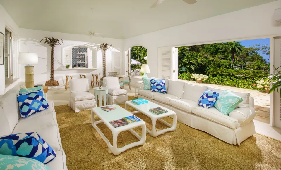 Villa living room with white sofas and garden views at Round Hill Hotel And Villas.