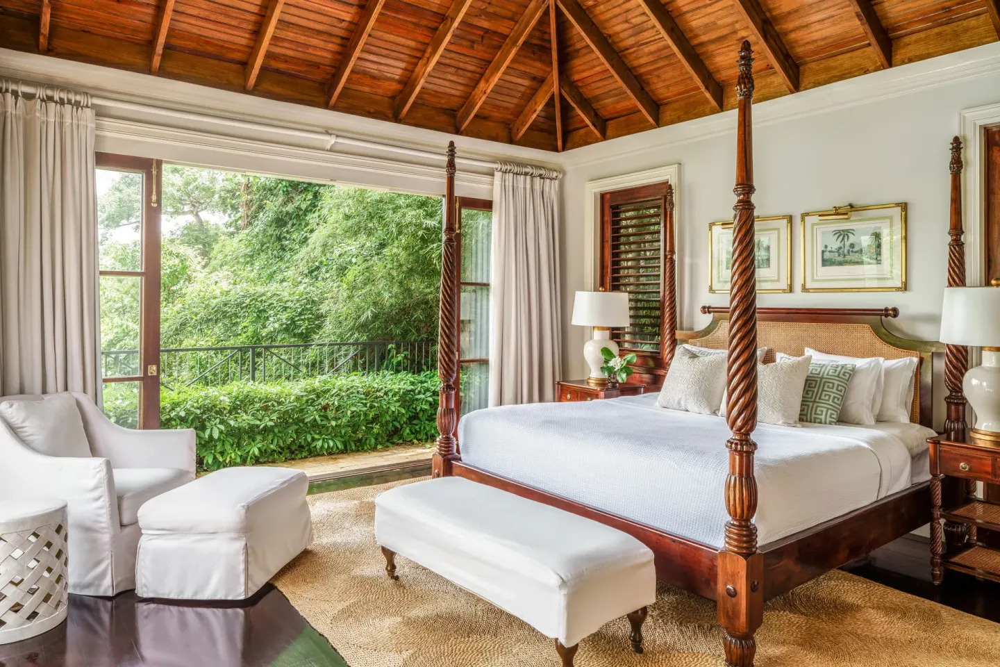 Four-poster bed beneath a wood ceiling in a suite at Round Hill Hotel And Villas.
