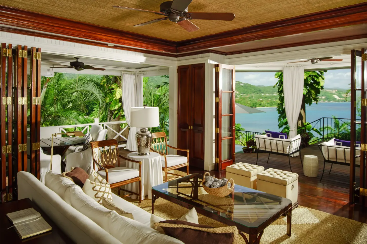 Ocean view suite living room with terrace seating at Round Hill Hotel And Villas.