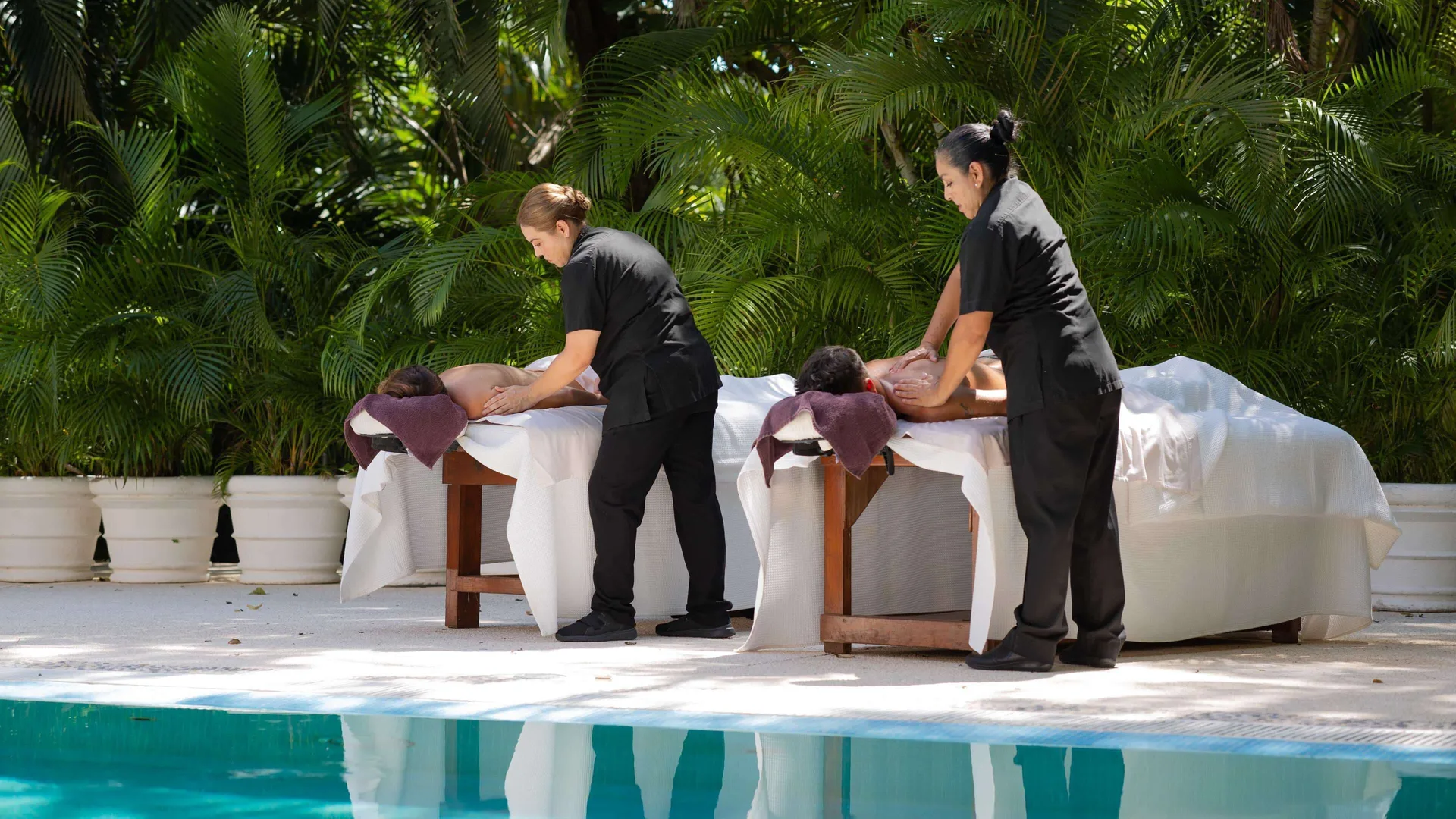 Poolside outdoor massages with tropical plants at Royal Hideaway Playacar.