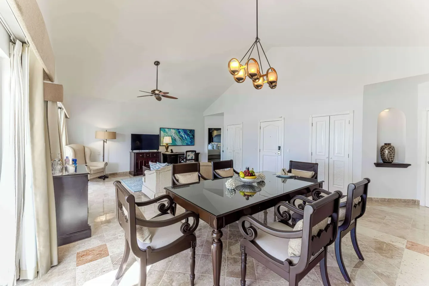Suite dining table and lounge area beneath vaulted ceilings at Royal Hideaway Playacar.