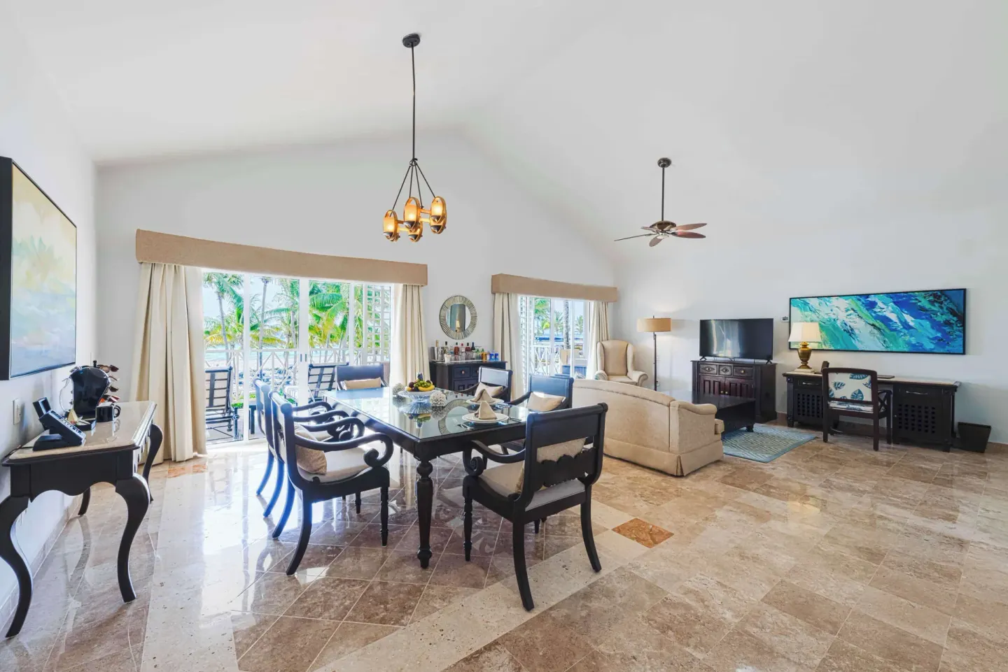 Suite living and dining area with balcony doors at Royal Hideaway Playacar.